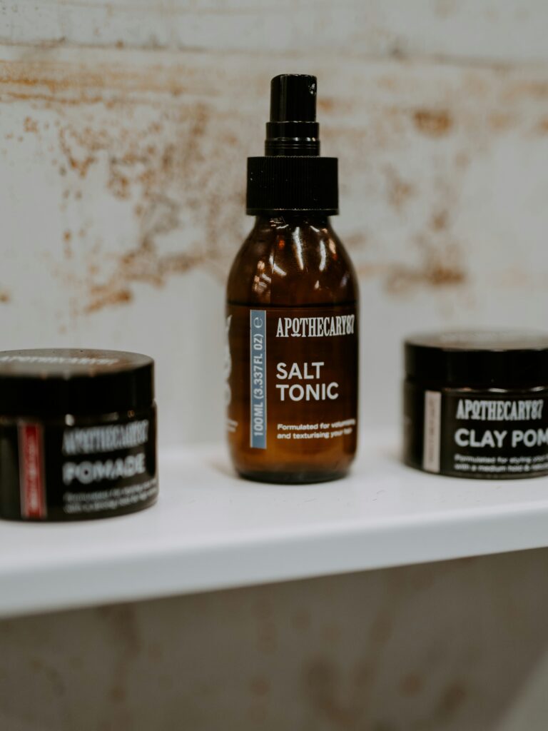 [ALT_TEXT: A range of hair styling products for mullet haircuts in brown containers on a white shelf.]